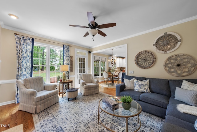 107 Ackworth Ct, Cary, NC 27519 - living area featuring wood finished floors, ornamental molding, plenty of natural light, a chandelier, and ceiling fan