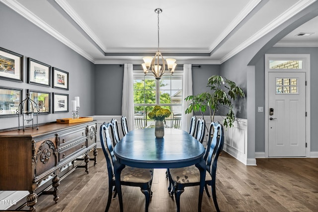 124 Moss Creek Pl, Fuquay Varina, NC 27526 - dining room featuring a raised ceiling, a chandelier, hardwood / wood-style flooring, plenty of natural light, and ornamental molding