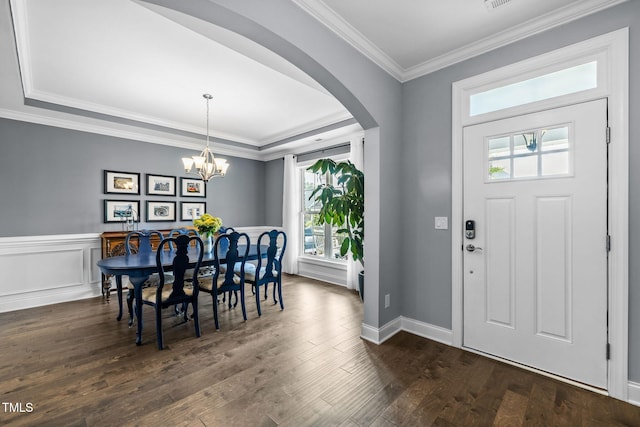 124 Moss Creek Pl, Fuquay Varina, NC 27526 - dining room with arched walkways, plenty of natural light, dark wood-type flooring, ornamental molding, and a chandelier