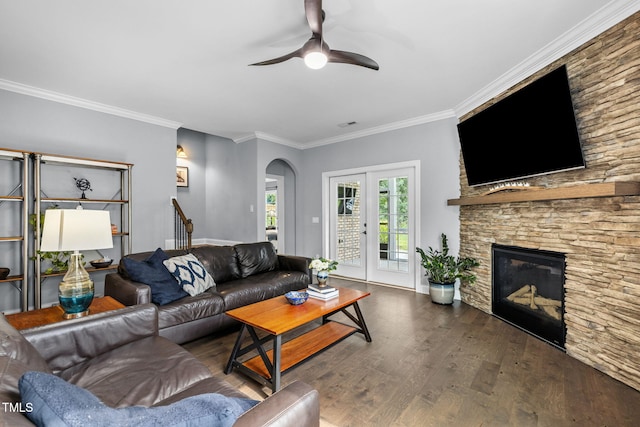 124 Moss Creek Pl, Fuquay Varina, NC 27526 - living area featuring a ceiling fan, arched walkways, wood finished floors, ornamental molding, and a stone fireplace