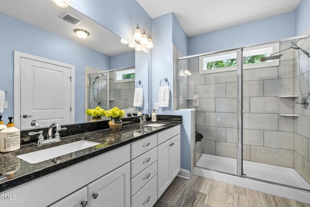 124 Moss Creek Pl, Fuquay Varina, NC 27526 - bathroom featuring a stall shower, healthy amount of natural light, and double vanity
