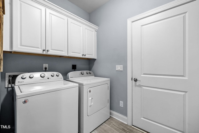 124 Moss Creek Pl, Fuquay Varina, NC 27526 - laundry area with cabinet space, washing machine and clothes dryer, and light wood-type flooring