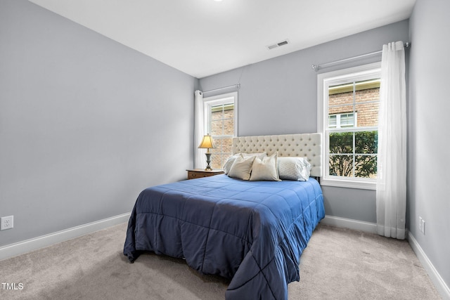 124 Moss Creek Pl, Fuquay Varina, NC 27526 - bedroom featuring multiple windows and light colored carpet