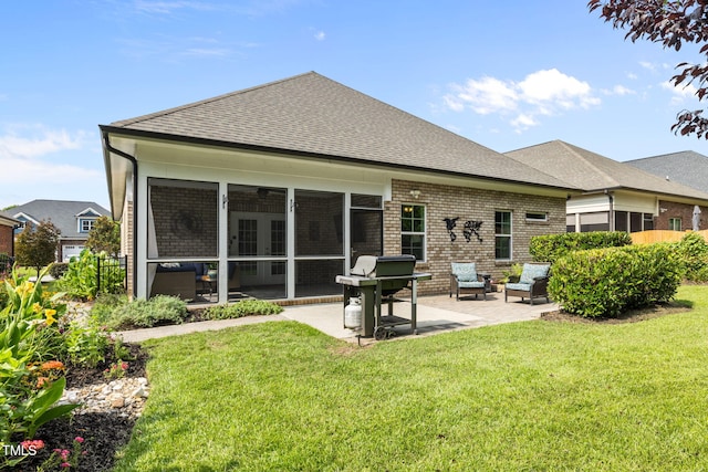 124 Moss Creek Pl, Fuquay Varina, NC 27526 - rear view of property featuring a patio area, a sunroom, a shingled roof, brick siding, and a yard