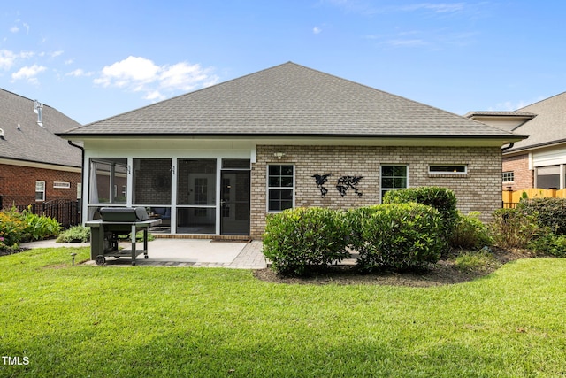 124 Moss Creek Pl, Fuquay Varina, NC 27526 - back of house featuring a sunroom, a patio, brick siding, and roof with shingles