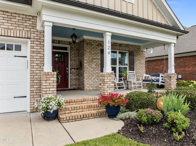 124 Moss Creek Pl, Fuquay Varina, NC 27526 - doorway to property with covered porch, board and batten siding, brick siding, an attached garage, and a surveillance system