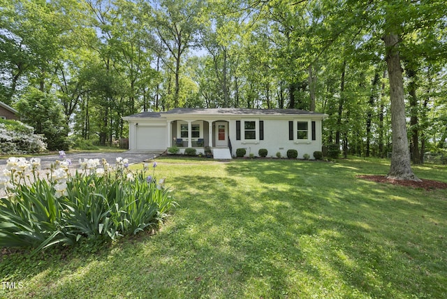 8613 Lobelia St, Raleigh, NC 27603 - view of front of home featuring an attached garage, driveway, a porch, and a front yard