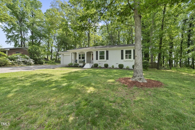 8613 Lobelia St, Raleigh, NC 27603 - ranch-style house featuring a garage, driveway, a front lawn, and a porch