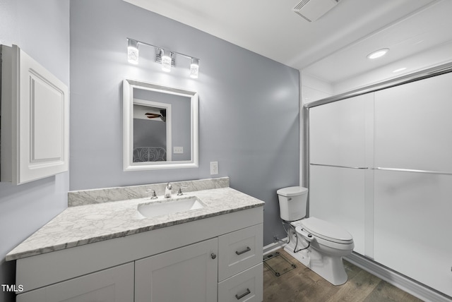 8613 Lobelia St, Raleigh, NC 27603 - bathroom featuring a shower stall, vanity, and wood finished floors
