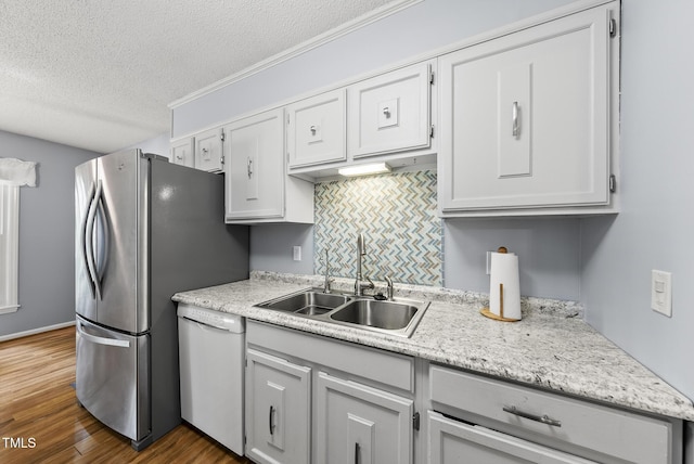 8613 Lobelia St, Raleigh, NC 27603 - kitchen with dishwasher, a textured ceiling, light countertops, dark wood-style floors, and freestanding refrigerator