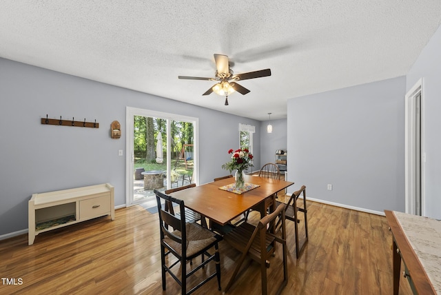 8613 Lobelia St, Raleigh, NC 27603 - dining space featuring wood finished floors, ceiling fan, and a textured ceiling