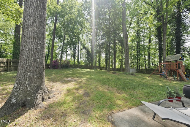 8613 Lobelia St, Raleigh, NC 27603 - fenced backyard featuring a playground