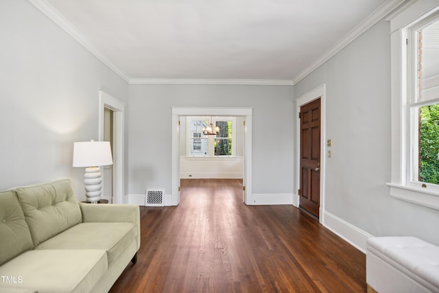 2005 Glenwood Ave, Raleigh, NC 27608 - living area featuring healthy amount of natural light, dark wood-type flooring, a chandelier, and ornamental molding