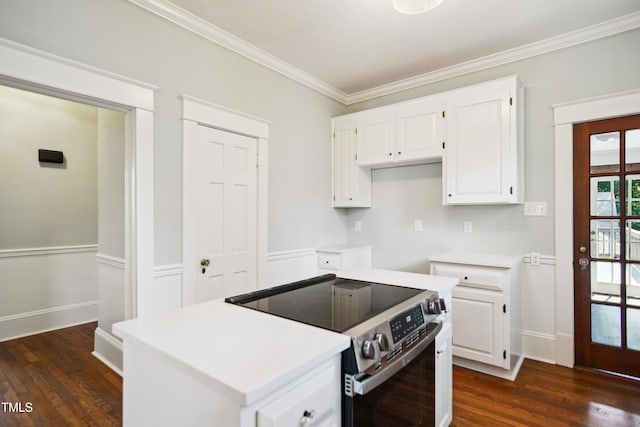 2005 Glenwood Ave, Raleigh, NC 27608 - kitchen with stainless steel range with electric cooktop, dark wood-style flooring, ornamental molding, white cabinets, and light countertops