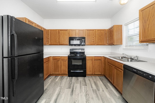 524 Summer Breeze Dr, Durham, NC 27704 - kitchen featuring black appliances, light wood-style flooring, light countertops, and brown cabinets