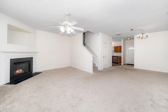 524 Summer Breeze Dr, Durham, NC 27704 - unfurnished living room featuring light colored carpet, a fireplace with flush hearth, a chandelier, a ceiling fan, and stairs