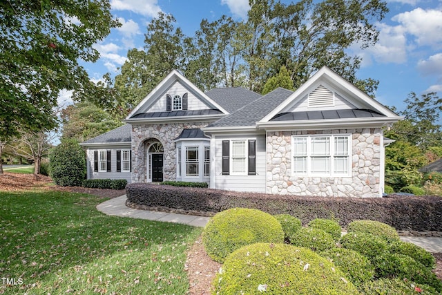 11 Kingswood Ln, Chapel Hill, NC 27517 - view of front of property featuring a standing seam roof, stone siding, a metal roof, a front lawn, and a shingled roof