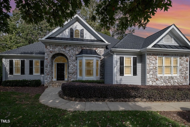 11 Kingswood Ln, Chapel Hill, NC 27517 - view of front of home featuring stone siding, a standing seam roof, a shingled roof, and a metal roof