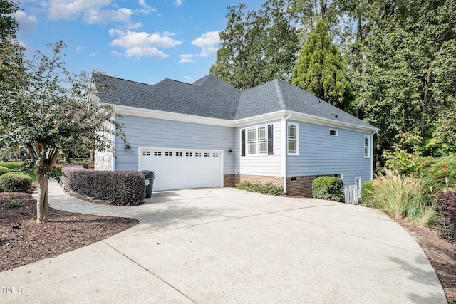 11 Kingswood Ln, Chapel Hill, NC 27517 - view of side of home featuring roof with shingles, a garage, and driveway