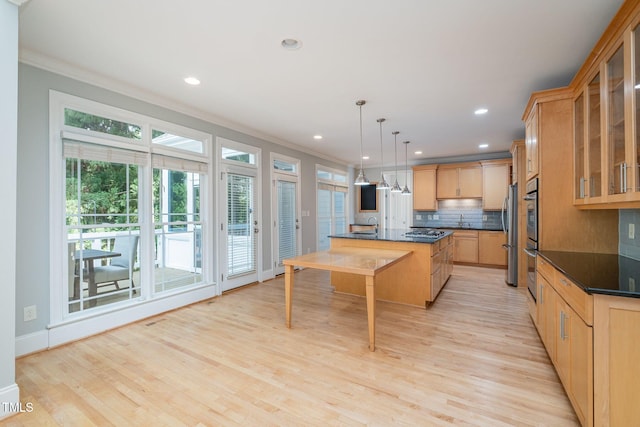 11 Kingswood Ln, Chapel Hill, NC 27517 - kitchen featuring ornamental molding, dark countertops, decorative backsplash, a kitchen island with sink, and light wood-style floors