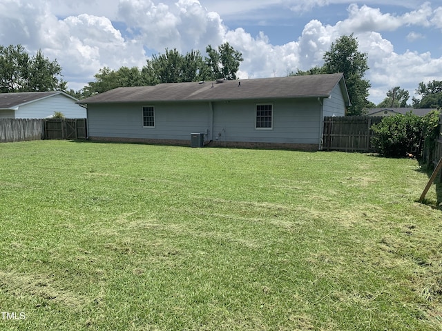 5574 Heather St, Hope Mills, NC 28348 - back of property featuring a fenced backyard and a shingled roof