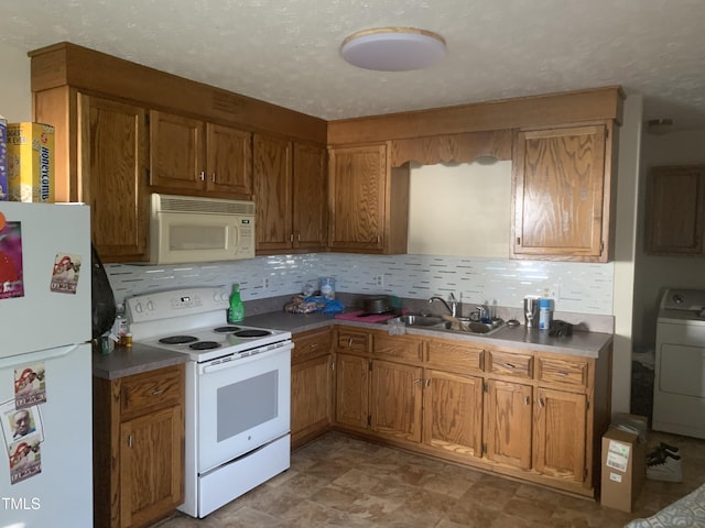 5574 Heather St, Hope Mills, NC 28348 - kitchen with white appliances, washer / dryer, decorative backsplash, and brown cabinets