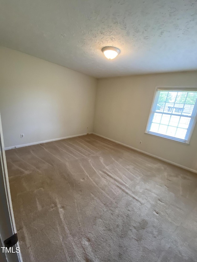 5574 Heather St, Hope Mills, NC 28348 - empty room with carpet floors and a textured ceiling