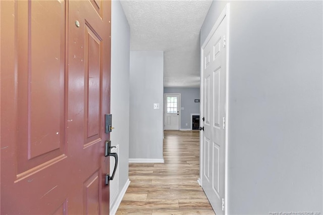 1591 Hazelcrest Dr, Fayetteville, NC 28304 - foyer featuring light wood-style flooring and a textured ceiling