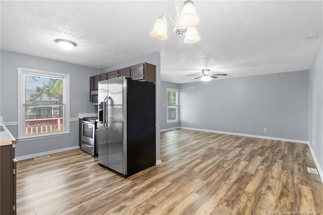 1591 Hazelcrest Dr, Fayetteville, NC 28304 - kitchen featuring stainless steel appliances, a textured ceiling, wood finished floors, a chandelier, and ceiling fan