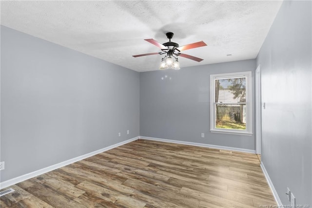 1591 Hazelcrest Dr, Fayetteville, NC 28304 - unfurnished room featuring a textured ceiling, wood finished floors, and ceiling fan