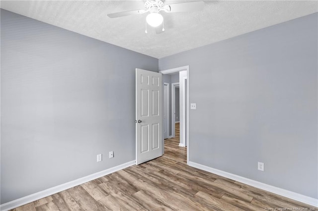 1591 Hazelcrest Dr, Fayetteville, NC 28304 - empty room featuring a textured ceiling, wood finished floors, and ceiling fan