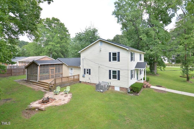 3300 Shaftsbury Drive St, Durham, NC 27704 - back of property with a fire pit, a deck, and view of scattered trees