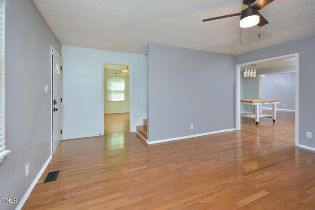 3300 Shaftsbury Drive St, Durham, NC 27704 - empty room with a ceiling fan, wood finished floors, a textured ceiling, and stairs