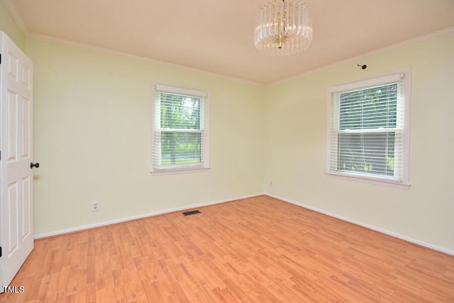 3300 Shaftsbury Drive St, Durham, NC 27704 - spare room featuring crown molding, a chandelier, and light wood-style floors