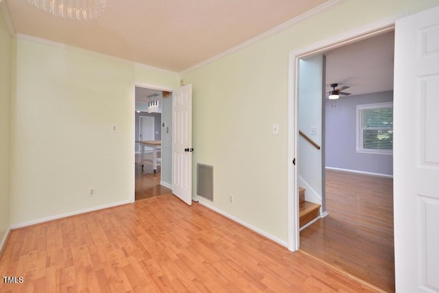 3300 Shaftsbury Drive St, Durham, NC 27704 - empty room with crown molding, light wood-style flooring, and stairs