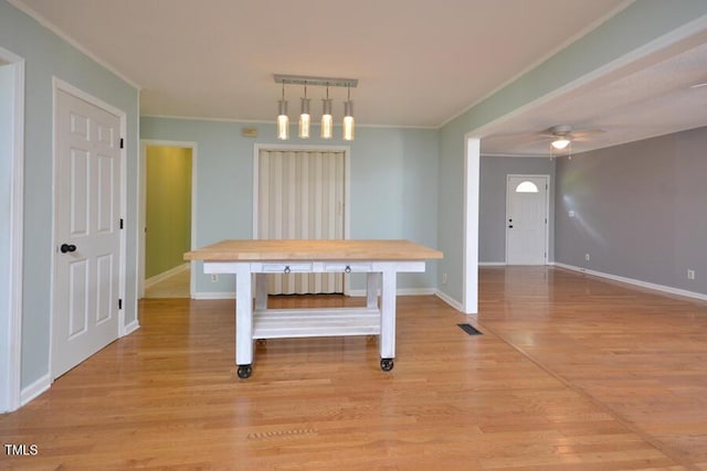 3300 Shaftsbury Drive St, Durham, NC 27704 - unfurnished dining area featuring crown molding, light wood finished floors, ceiling fan, and track lighting