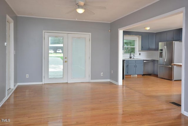 3300 Shaftsbury Drive St, Durham, NC 27704 - unfurnished living room with crown molding, ceiling fan, light wood-type flooring, and french doors