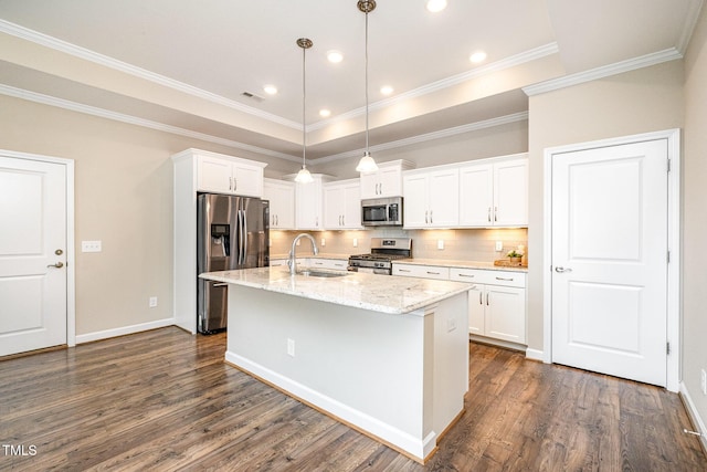 1164 Hudson Dr, Mebane, NC 27302 - kitchen with stainless steel appliances, dark wood-style flooring, white cabinetry, a kitchen island with sink, and crown molding