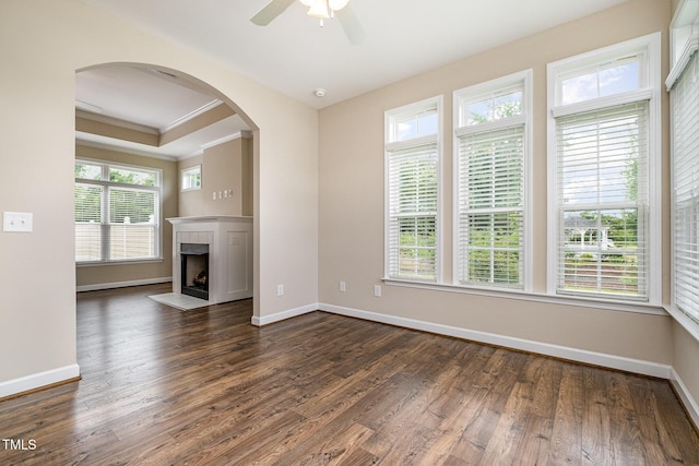 1164 Hudson Dr, Mebane, NC 27302 - unfurnished living room with ceiling fan, dark wood finished floors, ornamental molding, a tile fireplace, and arched walkways