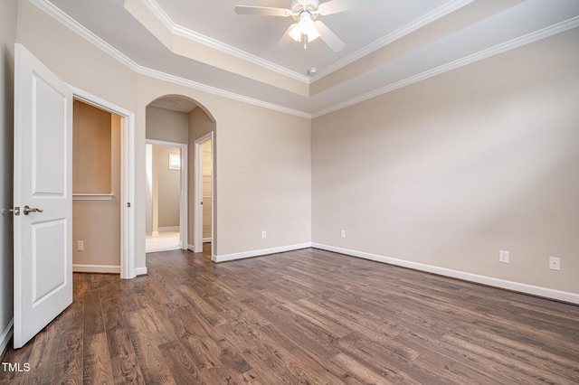 1164 Hudson Dr, Mebane, NC 27302 - unfurnished room with arched walkways, dark wood-style flooring, a tray ceiling, ceiling fan, and ornamental molding