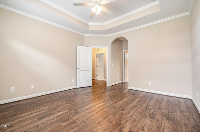 1164 Hudson Dr, Mebane, NC 27302 - unfurnished room featuring arched walkways, wood finished floors, ceiling fan, a tray ceiling, and ornamental molding