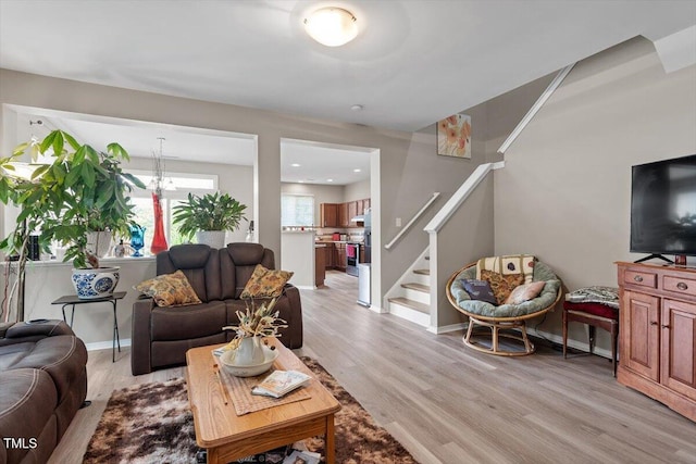 1742 Whirlaway Ct, Cary, NC 27519 - living room featuring light wood finished floors, stairway, and recessed lighting