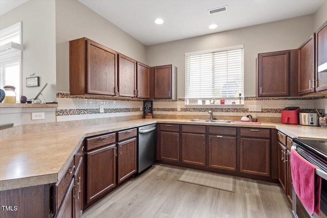 1742 Whirlaway Ct, Cary, NC 27519 - kitchen featuring appliances with stainless steel finishes, light countertops, light wood-style floors, tasteful backsplash, and recessed lighting