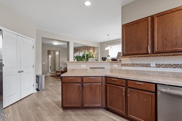 1742 Whirlaway Ct, Cary, NC 27519 - kitchen featuring dishwasher, light countertops, light wood finished floors, and a peninsula