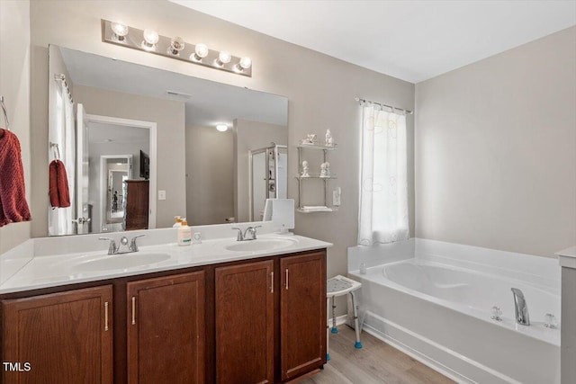 1742 Whirlaway Ct, Cary, NC 27519 - full bath with double vanity, a bath, and wood finished floors