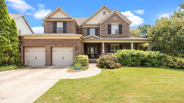 1019 Falkirk Dr, Burlington, NC 27215 - view of front of home featuring a front yard, driveway, a garage, and brick siding