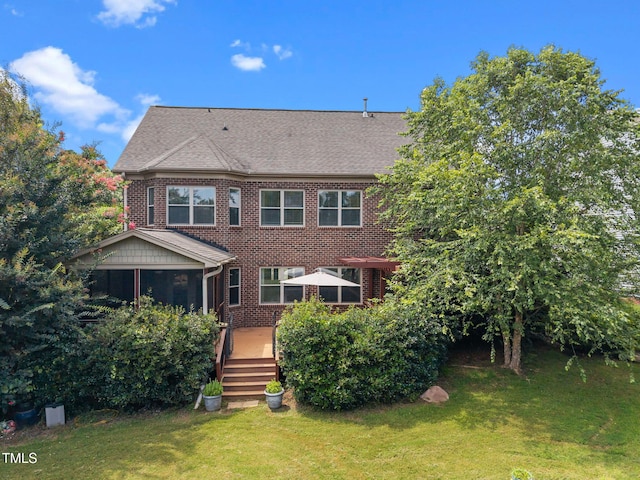1019 Falkirk Dr, Burlington, NC 27215 - back of property featuring brick siding, a deck, a lawn, and a shingled roof