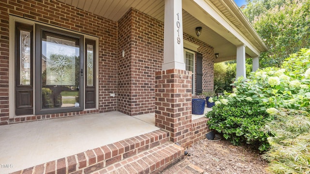 1019 Falkirk Dr, Burlington, NC 27215 - doorway to property featuring a porch and brick siding
