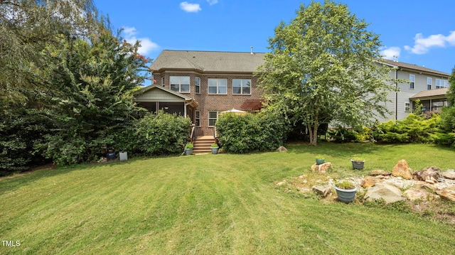 1019 Falkirk Dr, Burlington, NC 27215 - back of property with a yard, brick siding, and a wooden deck