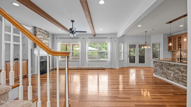 1019 Falkirk Dr, Burlington, NC 27215 - unfurnished living room featuring beam ceiling, a ceiling fan, light wood-type flooring, a fireplace, and recessed lighting